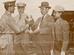 Cadet Capt. Paul L. Shackleford recieves a trophy from President Johnson. His unit C, won the Company Drill. [with Jacqueline Frazier]