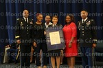 [Cadet Parker poses with family and ROTC leadership at the 2016 Army ROTC Commissioning Ceremony]