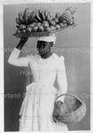 Woman arrying a Fruit Tray on Her Head with a Basket in Hand
