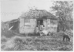 Three People and Livestock Standing by a Residence with a Thatched Roof
