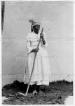 Woman holding a Long Wooden Farming Tool