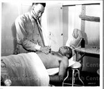 Lieutenant Ned Manley of Howard University examines a patient