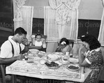 Anacostia, D.C. Frederick Douglass Housing Project. A family says grace before the evening meal. June 1942 by Gordon Parks