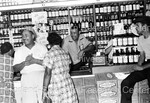 Joe Louis behind the counter of liquor store by Harold Hargis