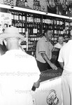Joe Louis standing behind the counter of a liquor store by Harold Hargis