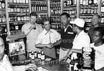 Joe Louis shaking hands with man at liquor store by Harold Hargis