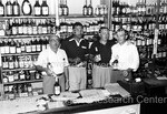 Joe Louis behind the counter of liquor store with 3 men - 2 by Harold Hargis
