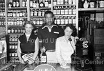 Joe Louis holding a bottle Joe Louis Bourbon with 2 women by Harold Hargis