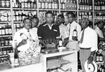 Joe Louis posing with 5 men at liquor store - 2 by Harold Hargis
