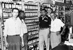 Joe Louis posing with 4 men behind the counter of a liquor store - 2 by Harold Hargis