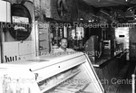 Unidentified man standing at deli counter by Harold Hargis