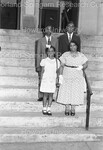 Woman and 3 children pictured on church steps. by Harold Hargis