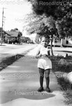 Child Standing on Sidewalk - 1 by Harold Hargis
