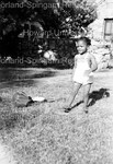 Child Standing on Lawn by Harold Hargis