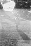 Child Standing on a Lawn in the Sun by Harold Hargis
