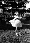 Child Standing on a Lawn in a White Dress by Harold Hargis