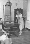 Unidentified Woman posing at dining room table by Harold Hargis