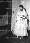 Bride standing holding flowers by Harold Hargis