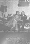 2 wedding guests posing on a couch - 1 by Harold Hargis