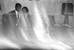 Blurred image of 2 people posing on a couch by Harold Hargis