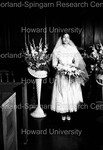 Bride at wedding; holding flowers by Harold Hargis