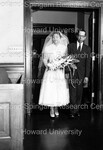 Bride being escorted down the aisle by Harold Hargis