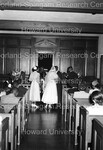 Wedding party at the alter; shoot from behind the wedding party by Harold Hargis
