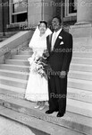 Bride and Groom on church steps; after the wedding by Harold Hargis