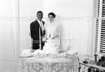 Bride and Groom cutting the wedding cake by Harold Hargis