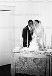 Bride feeding Groom a piece of wedding cake by Harold Hargis