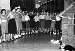 Newly minted members of Delta Sigma Theta line up to dance as everyone around them watch - 3 by Hargis Harold