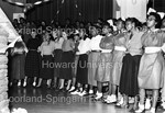 Newly minted members of Delta Sigma Theta line up to dance as everyone around them watch - 5 by Hargis Harold
