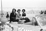 Three ladies in the back of a car during the homecoming parade - 1 by Harold Hargis