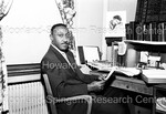 Man Photographed Sitting at Desk - 2 by Harold Hargis