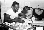 Man Photographed Inside Working at Desk by Harold Hargis