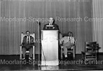 Mordecai W. Johnson standing at podium delivering speech by Harold Hargis