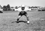 Football player #55 in a football stance by Harold Hargis
