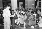 Unidentified Man standing at podium in front of large group - 1 by Harold Hargis