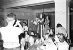 Unidentified people dancing in chairs as others observe by Harold Hargis