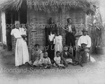Ten People in Front of a House with a Thatched Roof