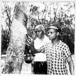 Dr. Mays and Young Man in Africa with Rubber Tree