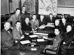 Men and One Woman Seated in a Board Room