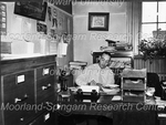 Unidentified Man working at his Desk