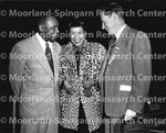 Unidentified actors with woman in leopard coat smiling in center