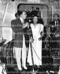 Unidentified Man and Woman at Microphone