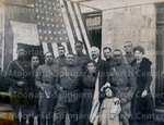 Soldiers and a little girl standing by the United states of America flag